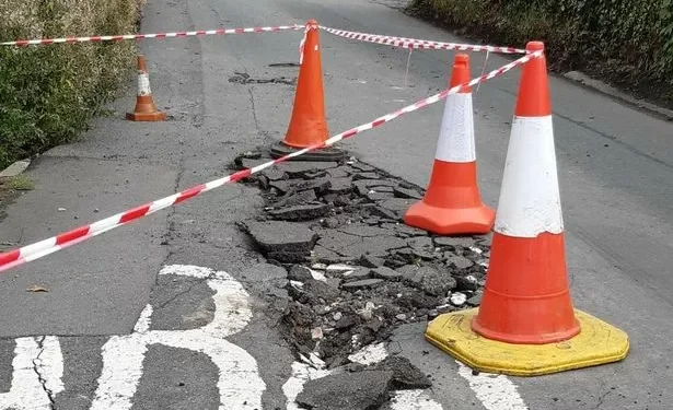 Road closed as large sinkhole opens up