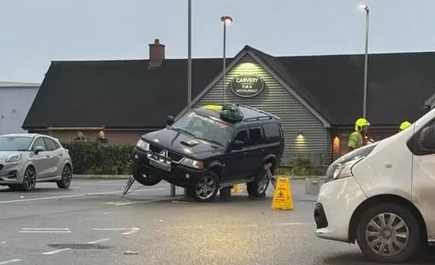 Car rescued by fire service after getting stuck on supermarket bollards