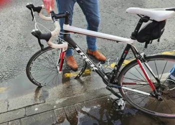Cyclist flung over handlebars after hitting hidden pothole on main city road