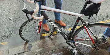 Cyclist flung over handlebars after hitting hidden pothole on main city road