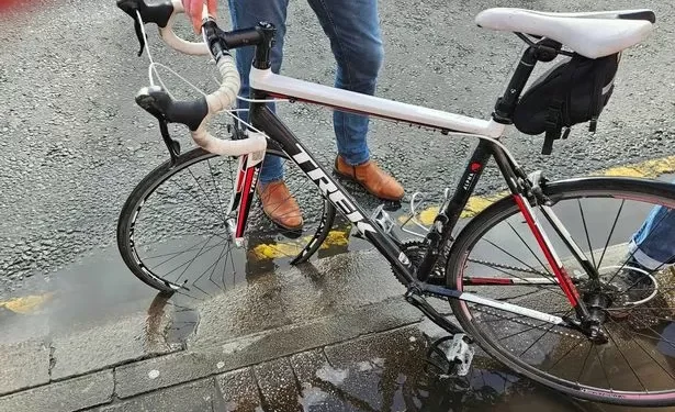 Cyclist flung over handlebars after hitting hidden pothole on main city road