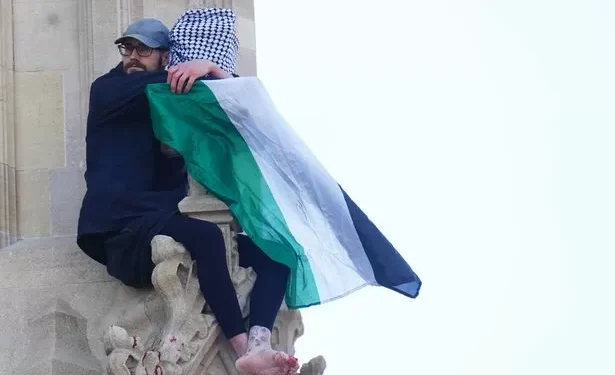 Man climbs Big Ben and drapes himself in Palestine flag as police shut Westminster Bridge
