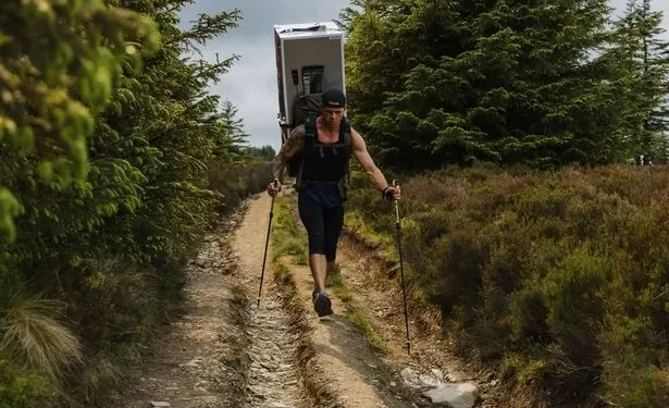 Man treks 70 miles across Welsh mountains with a fridge on his back in memory of his wife