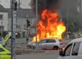 Dramatic footage shows crowds gather as car erupts into ’30ft’ flames