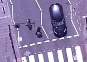 Dramatic moment police run through busy streets and floor drug dealer captured on helicopter camera