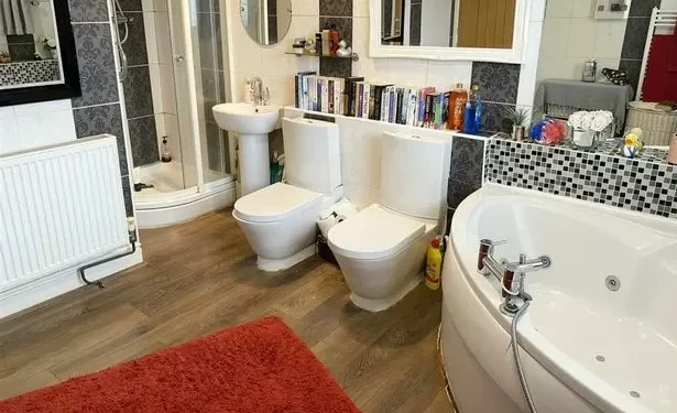 Home with two toilets next to each other in bathroom splits opinion
