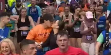 The adorable moment a man and a woman high five and kiss at the finish line of the Cardiff Half Marathon