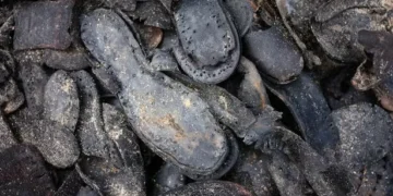 Hundreds of old and tattered shoes mysteriously found on Welsh beach